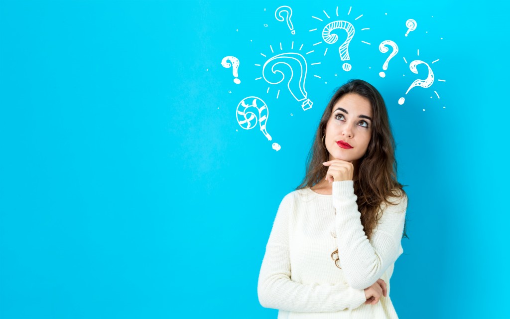 Question marks with young woman in a thoughtful face
